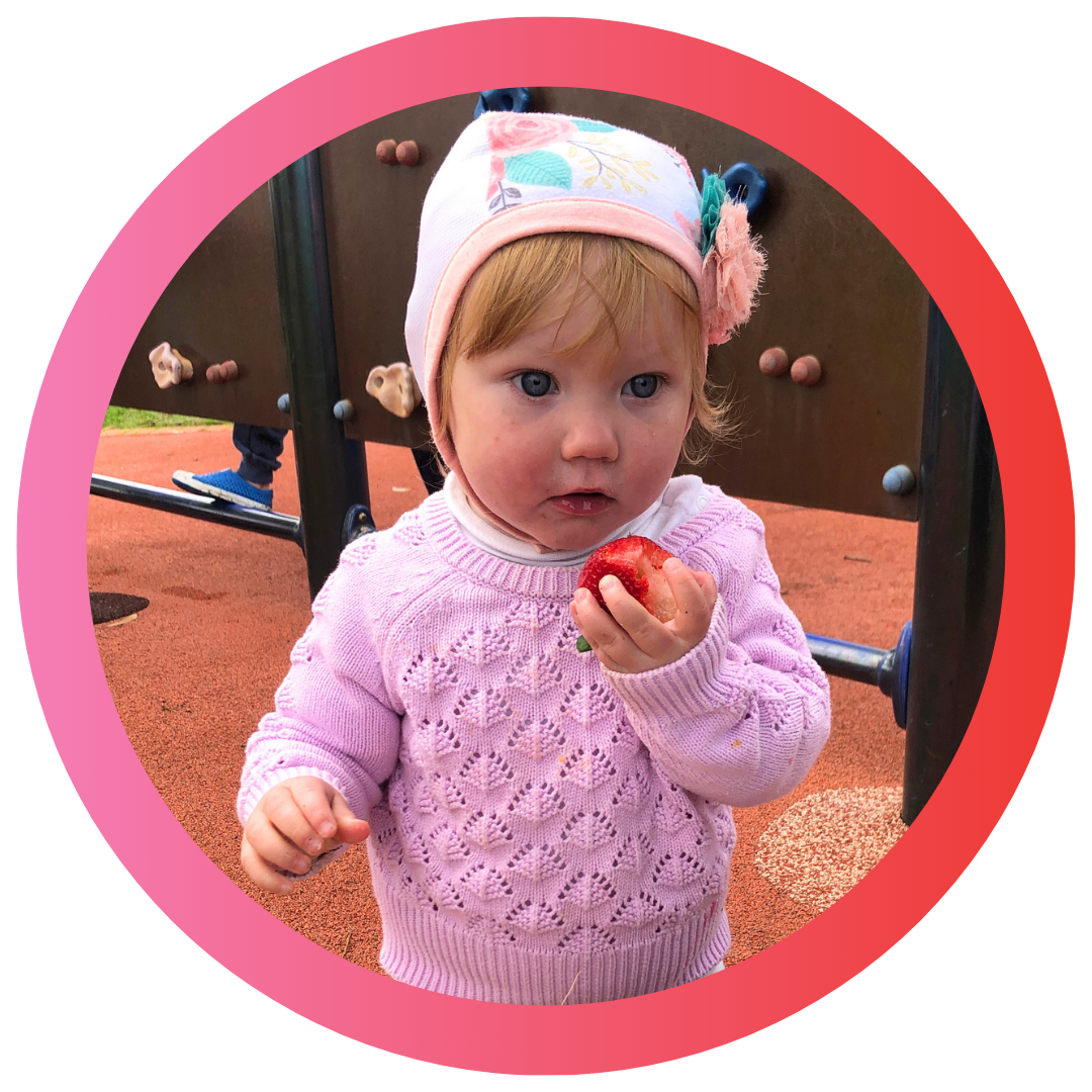 Young girl Grace wearing a hearing aid bonnet to keep her hearing aids in place